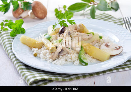 Chicken fricassee with fresh white asparagus, rice and mushrooms Stock Photo