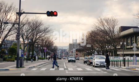 Kyoto, Japan - Dec 25, 2015. People and vehicles on street at sunset in Kyoto, Japan. Kyoto served as Japan capital and the emperor's residence from 7 Stock Photo