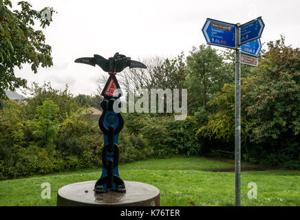 Cycle route 75 sign post directions on Water of Leith walkway and cycle path, Stedfastgate, Warriston, Trinity, Edinburgh, Scotland, on wet rainy day Stock Photo
