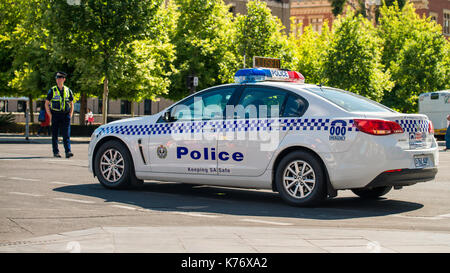 Adelaide, Australia - November 14, 2015: South Australian police car closed the street in  Adelaide's CBD with the policeman patrolling on the backgro Stock Photo