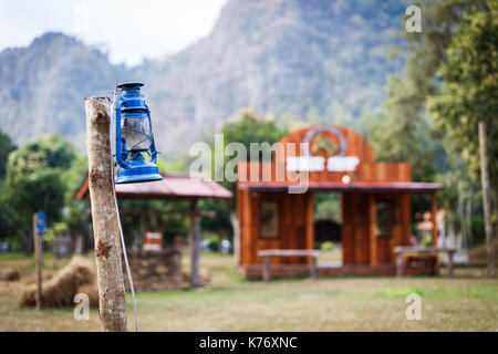 Some resort decorate their place in contry theme. They use old lantern, straw, well and backdrop that relate to cowboy style. Stock Photo