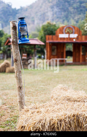 Some resort decorate their place in contry theme. They use old lantern, straw, well and backdrop that relate to cowboy style. Stock Photo