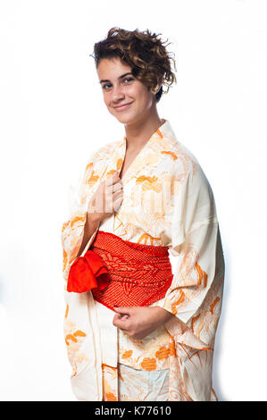 Close view of teen age girl dressed in casual Japanese Yukata kimono standing with hands close. Stock Photo