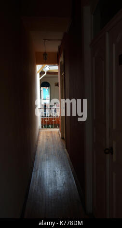 Narrow and dark corridor in the interior of a house Stock Photo