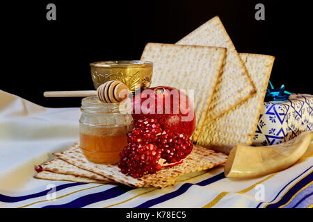 Honey and pomegranate for traditional holiday symbols rosh hashanah jewesh holiday on wooden table top and wooden background