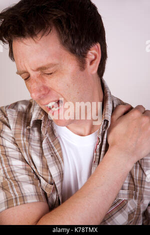 A sore shoulder joint muscle in a white man on a white background ache ...