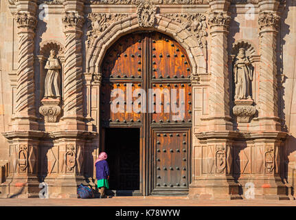 An indigenous woman at the entrance of a baroque church in the city center of Queretaro city, Mexico. Stock Photo