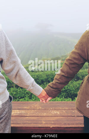 Young womens handshake, teenagers handshake in green nature background. Two hands together concept vintage. Stock Photo