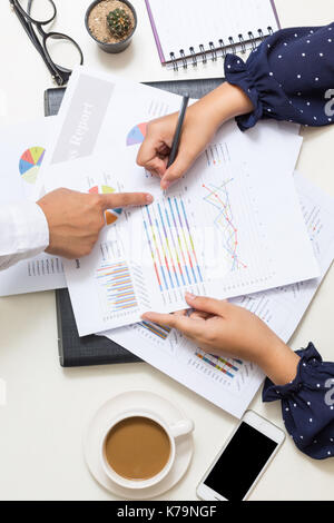 Close up of man and woman hand pointing at business document at meeting Stock Photo