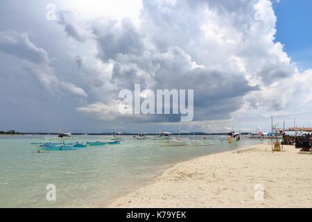 Storm clouds looming in the horizon of a sand bar in a tropical country. Stock Photo