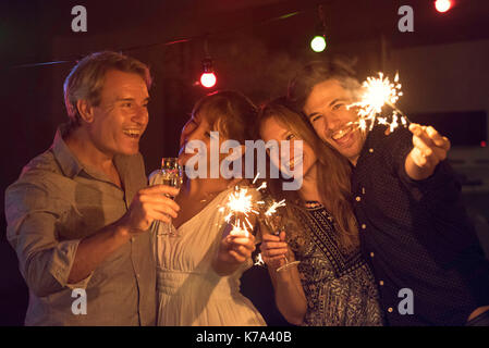 Friends celebrating with sparklers and champagne Stock Photo