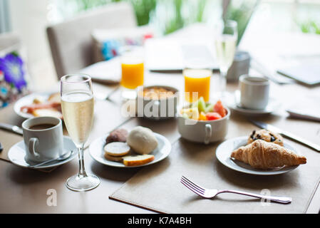 Glass of champagne on breakfast table in restaurant Stock Photo