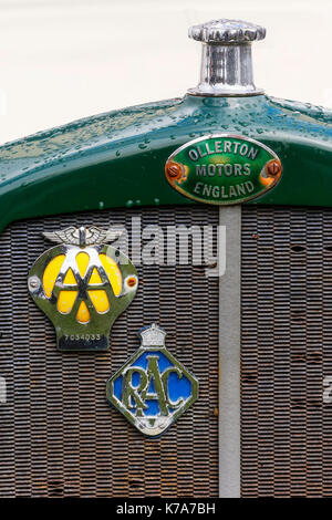 Front grill of an Ollerton van with an RAC badge and an AA badge screwed onto the rusty front grill. Stock Photo