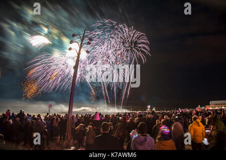 Blackpool, Lancashire, UK. 15th September, 2017. Exploding fireworks are fired over the sea from North Pier, creating a perfect arena at Tower Festival Headland on Blackpool promenade.  Some of the world’s best pyrotechnic artists were in town to light up the night sky in superb and spectacular fashion. The French entrant Brezac Artifices enthralled the thousands of tourists who had come to watch the event on the resort Tower Headland. Credit; MediaWorldImages/AlamyLiveNews. Stock Photo