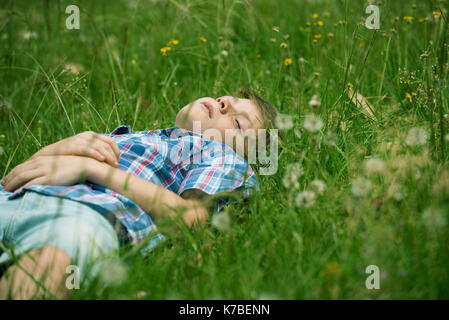 Boy napping on grass Stock Photo