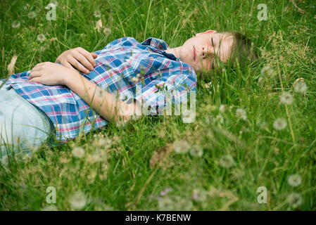 Boy napping on grass Stock Photo