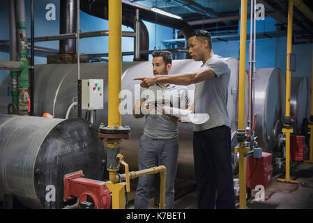 Men working in industrial setting Stock Photo