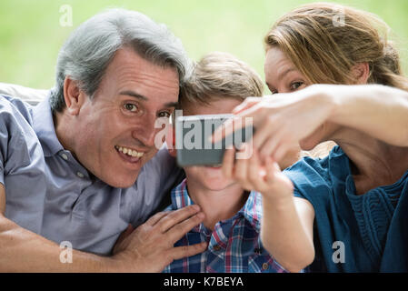 Family using smartphone to take a selfie Stock Photo