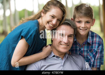 PORTRAIT SMILING FAMILY FATHER MOTHER TWO SONS STANDING TOGETHER IN ...