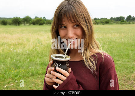 Young Argentinian woman drinking yerba mate