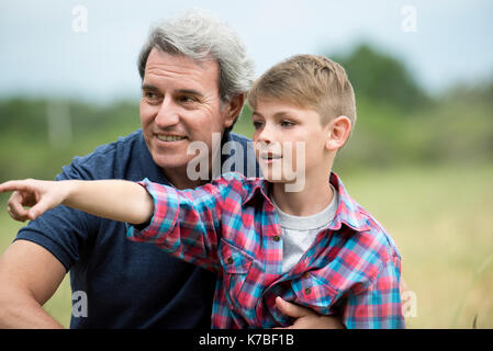 Grandfather and grandson spending time together outdoors Stock Photo