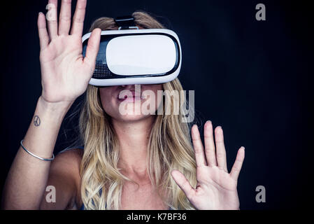 Woman using virtual reality simulator Stock Photo