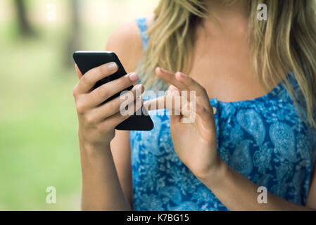 Woman using smartphone, cropped Stock Photo