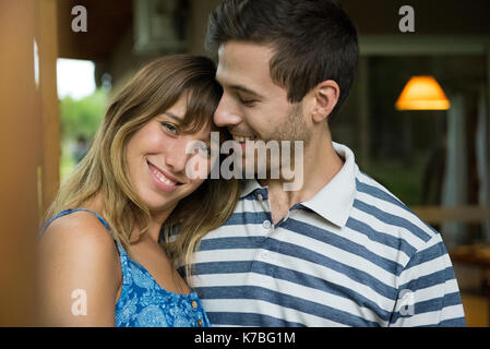 Young woman leaning head on boyfriend's shoulder, portrait Stock Photo