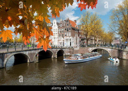 Traditional old houses on canal at fall day in Amsterdam, Netherlands at autumn season. Stock Photo