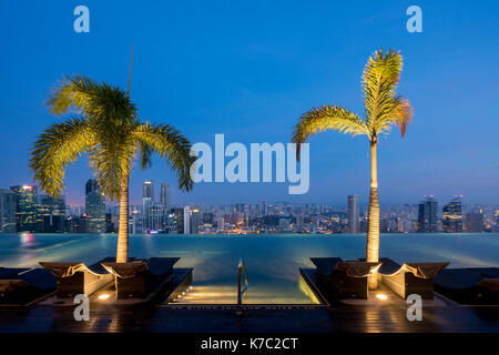 Swimming Pool on roof top and Singapore city skyline in night, Sinagpore Stock Photo