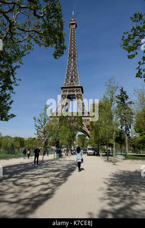 A woman standing in front of the Eiffel Tower in Paris, France. Stock Photo