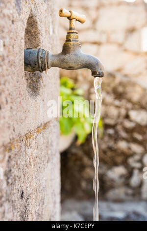 Old rusty water tap on fountain Stock Photo