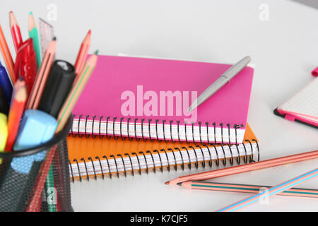 Stack of books and stationery isolated on white background Stock Photo