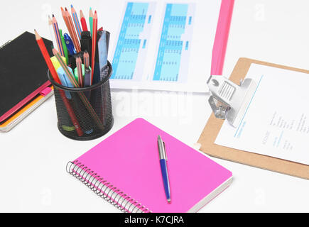Stack of books and stationery isolated on white background Stock Photo