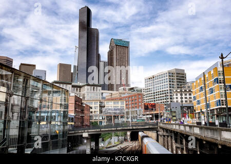 SEATTLE Cityscape showing skyline and a train entering the Great Northern Tunnel, built 1905, a one-mile double tracked railway tunnel Stock Photo