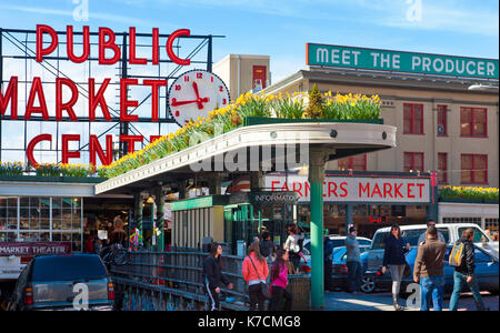 Seattle Public Market at Pike Place. View of famous iconic neon sign and crowds of shoppers Stock Photo