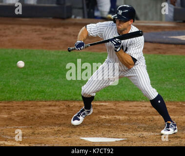 Brett Gardner of the New York Yankee slides through the legs of Texas  Rangers' pitcher Cliff Lee who forced him at first on a grounder to first  in the fourth inning during