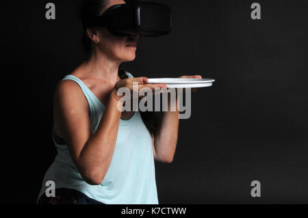 Woman using VR headset - concept image Stock Photo