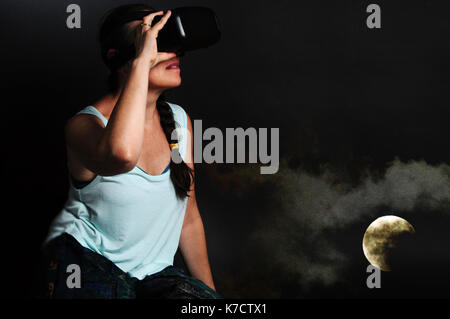 Woman using VR headset - concept image Stock Photo
