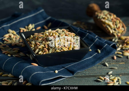 Dry Organic Tricolor Orzo Pasta in a Bowl Stock Photo