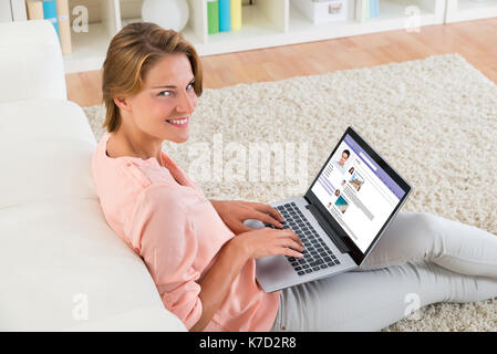 Young Happy Woman Chatting On Social Website Using Laptop At Home Stock Photo