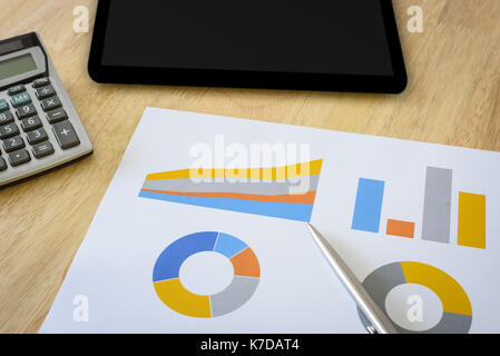 financial chart with calculator and digital tablet Stock Photo