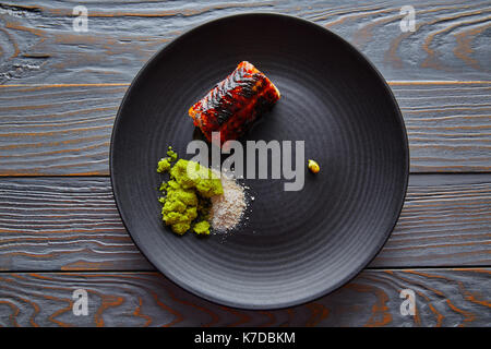 Grilled smoked eel with green apple and citrus with Sichuan Electric flower Stock Photo
