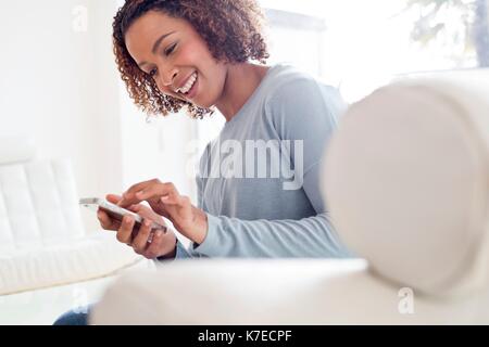 Mid adult woman using cell phone. Stock Photo