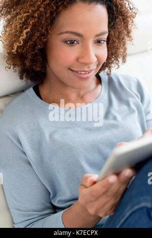 Mid adult woman using digital tablet. Stock Photo