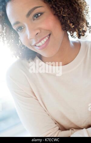 Mid adult woman looking away, smiling. Stock Photo