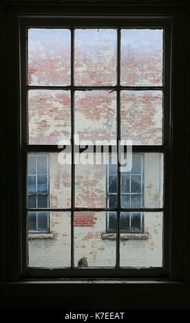 Windows looking out at exterior walls of E B Eddy paper mill complex in Ottawa, Canada, closed since 2007. Stock Photo