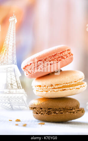Macaroon cookies stacked pastel colors selective focus. Eiffel Tower background Stock Photo
