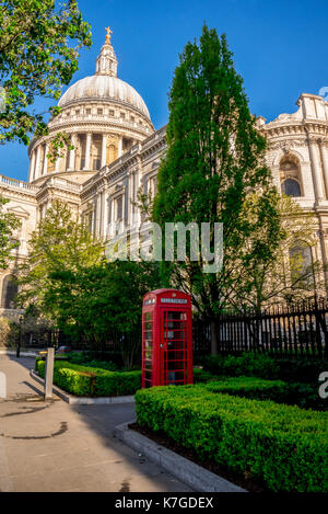 Iconic Red Telephone Booth in St Paul's Cathedral churchyard in central London, Great Britain Stock Photo