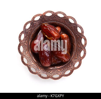 Plate of pitted dates isolated on white background. Top view